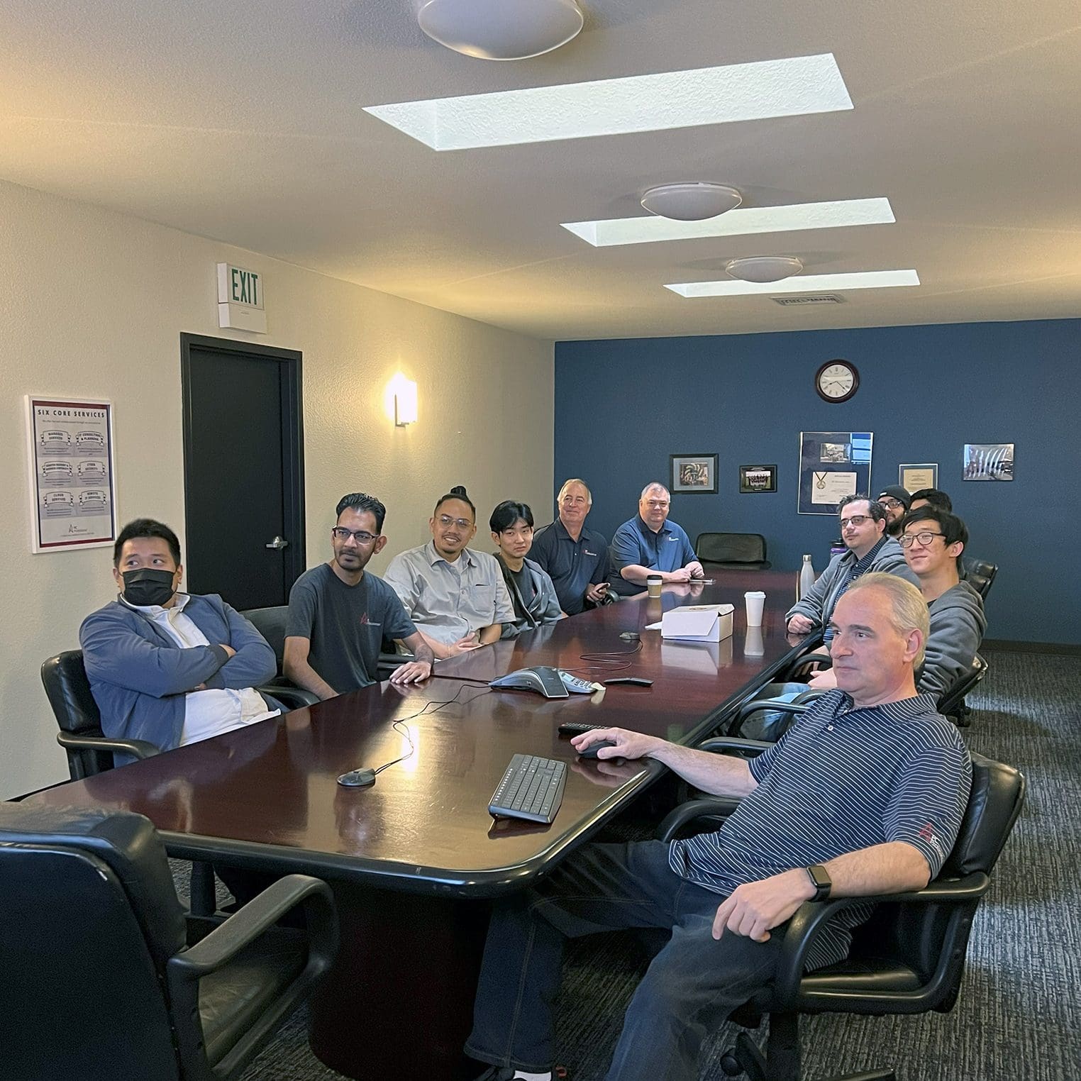 IT professionals around a conference table reviewing a cloud security assessment on screen