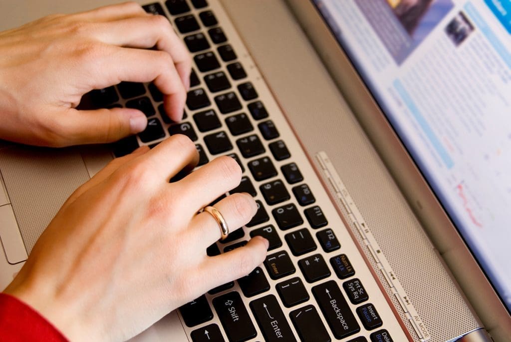 A person typing on a laptop.